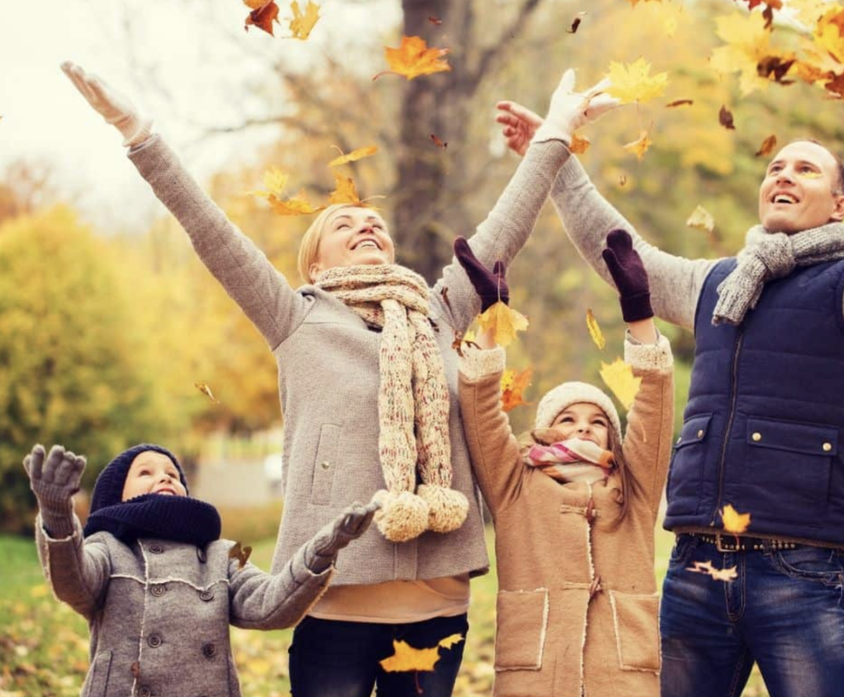 Family fun in a shower of leaves.